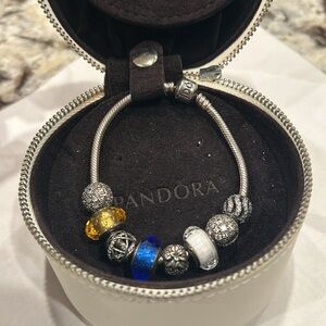 Beautiful Pandora bracket with 4 silver charms plus 4 more